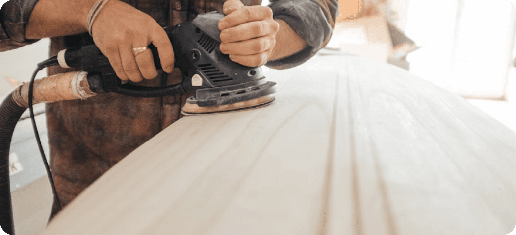 Craftsman sanding a hardwood floor